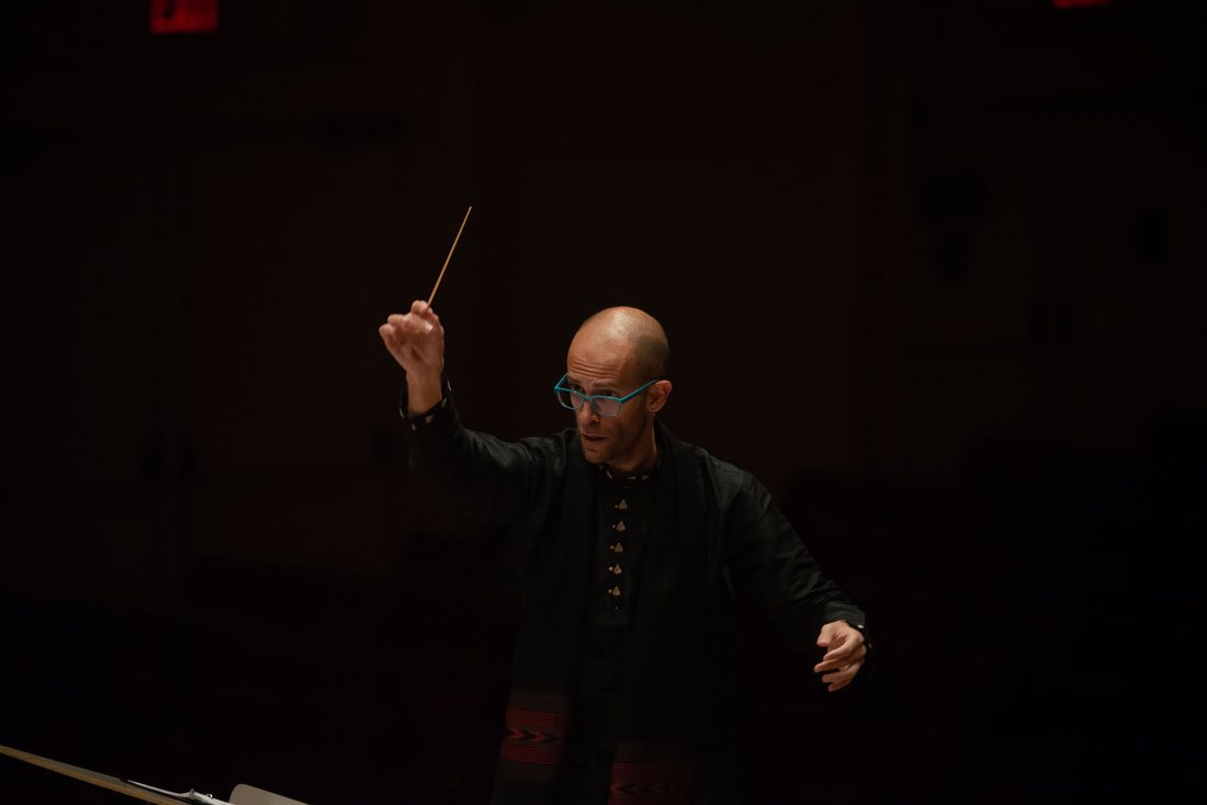 Amir Zaheri conducting, close up