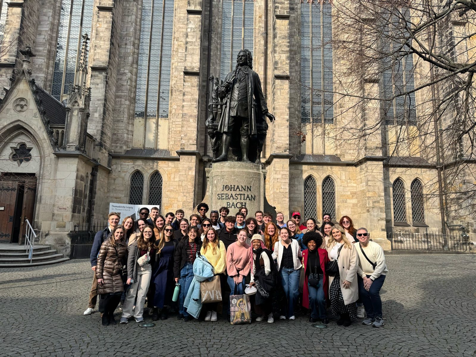 The University Singers at the Johann Sebastian Bach monument by St. Thomas Church in Leipzig